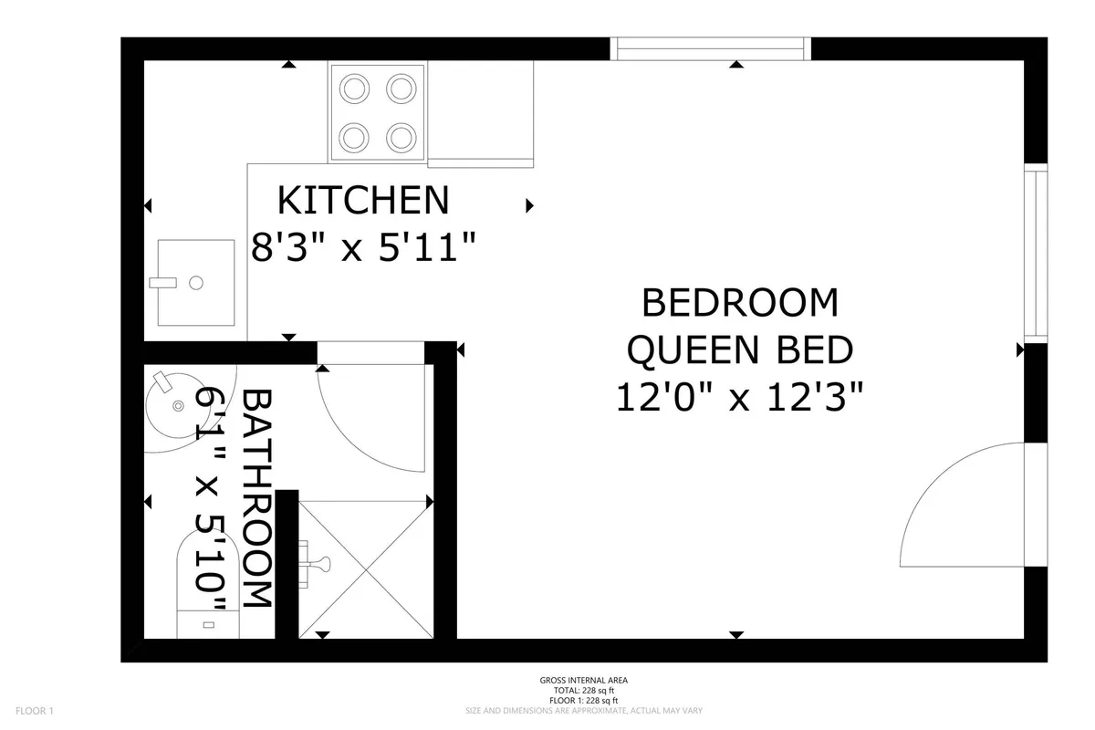 This image offers a practical perspective of the compact kitchen area, with a view that also includes a cozy queen bed and the entrance to the bathroom. It demonstrates how the kitchenette and living space connect, reinforcing the theme of homey convenience.
